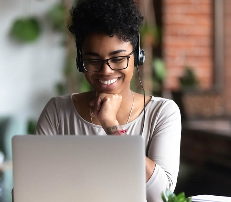 Girl with headphones on laptop